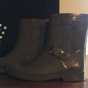 Army green coach rain boots.
